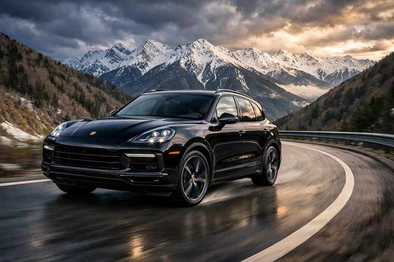 Premium car Porsche Cayenne on the background of Krasnaya Polyana mountains